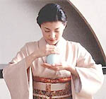 Woman smelling incense